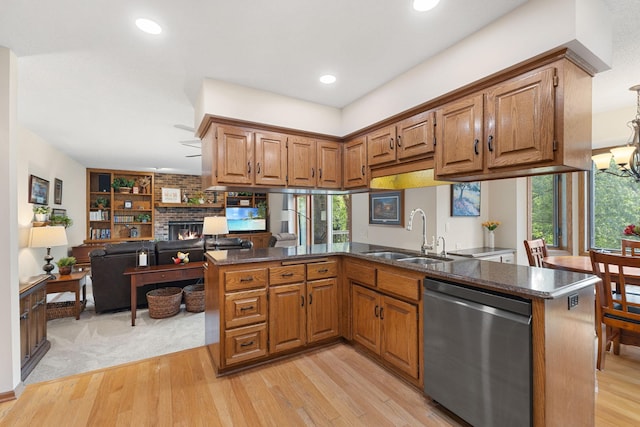 14023 Yellow Pine St NW, Andover, MN 55304 - kitchen with stainless steel dishwasher, brown cabinetry, light wood finished floors, a fireplace, and recessed lighting