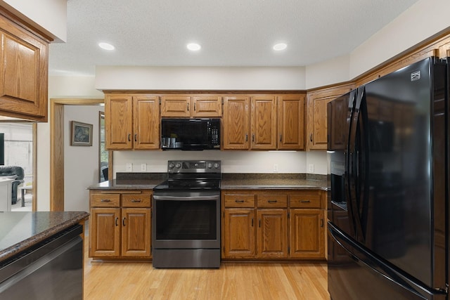 14023 Yellow Pine St NW, Andover, MN 55304 - kitchen with black appliances, dark countertops, brown cabinetry, and recessed lighting