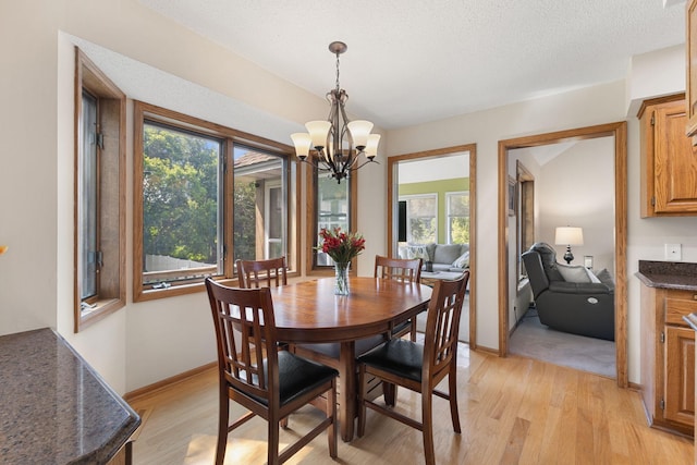 14023 Yellow Pine St NW, Andover, MN 55304 - dining area with light wood-type flooring and a chandelier