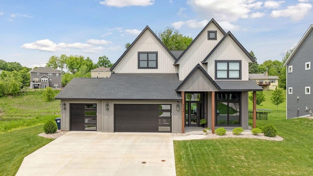 4998 Beach St NE, Prior Lake, MN 55372 - view of front facade with board and batten siding, concrete driveway, a shingled roof, and a front yard