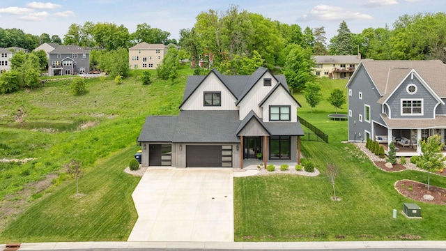 4998 Beach St NE, Prior Lake, MN 55372 - view of front of home featuring driveway, an attached garage, a front lawn, covered porch, and a residential view