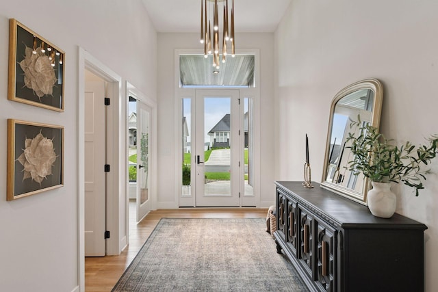 4998 Beach St NE, Prior Lake, MN 55372 - foyer entrance with light wood finished floors, a high ceiling, and baseboards