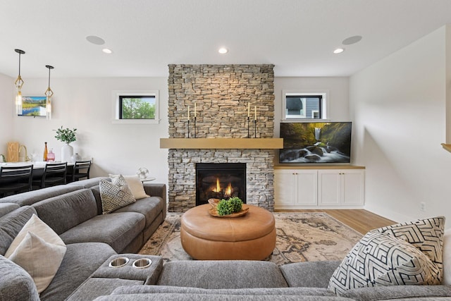 4998 Beach St NE, Prior Lake, MN 55372 - living room featuring wood finished floors, recessed lighting, and a stone fireplace