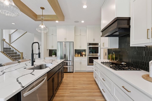 4998 Beach St NE, Prior Lake, MN 55372 - kitchen with stainless steel appliances, recessed lighting, white cabinetry, a sink, and hanging light fixtures
