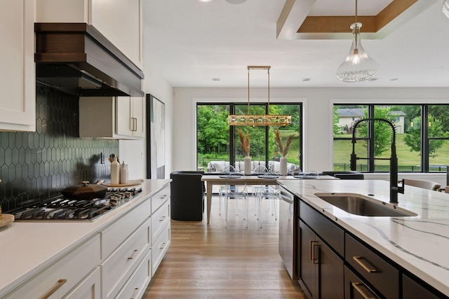 4998 Beach St NE, Prior Lake, MN 55372 - kitchen with a sink, appliances with stainless steel finishes, custom exhaust hood, decorative light fixtures, and backsplash