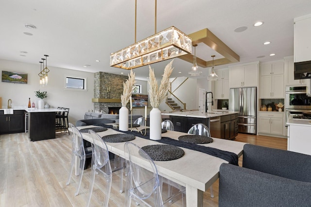 4998 Beach St NE, Prior Lake, MN 55372 - dining space with light wood-style floors, recessed lighting, and a stone fireplace