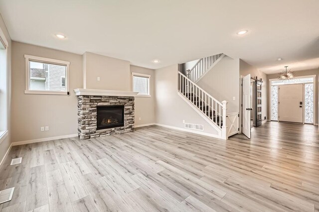 139 144th Ave NW, Andover, MN 55304 - unfurnished living room with plenty of natural light, wood finished floors, stairs, and recessed lighting