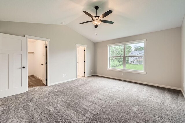 139 144th Ave NW, Andover, MN 55304 - unfurnished bedroom featuring carpet floors, vaulted ceiling, a walk in closet, and a ceiling fan
