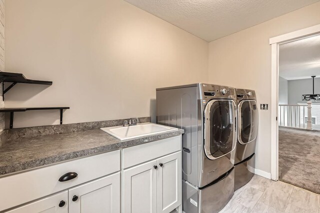 139 144th Ave NW, Andover, MN 55304 - laundry room with washer and clothes dryer, cabinet space, and light colored carpet