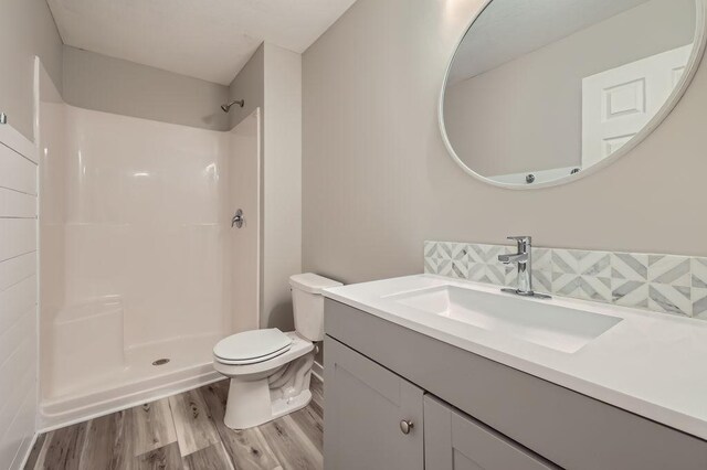 139 144th Ave NW, Andover, MN 55304 - full bathroom with wood finished floors, vanity, and a shower