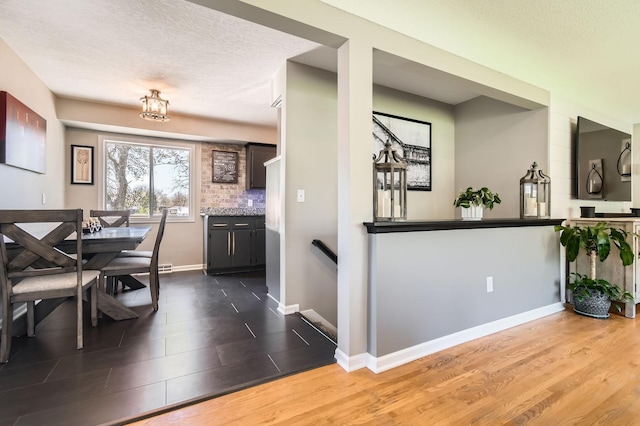 13812 Steven Rd, Burnsville, MN 55337 - dining space with dark wood-type flooring, baseboards, and a textured ceiling