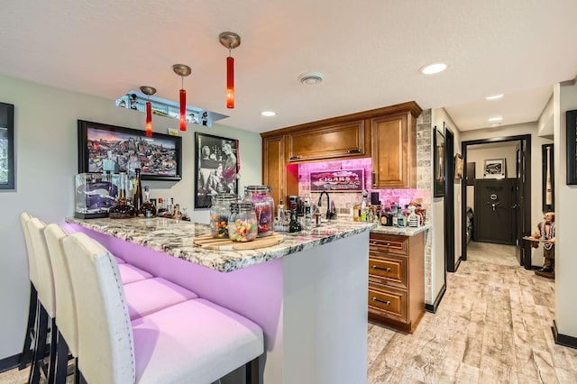13812 Steven Rd, Burnsville, MN 55337 - indoor wet bar with light wood-type flooring, recessed lighting, and hanging light fixtures