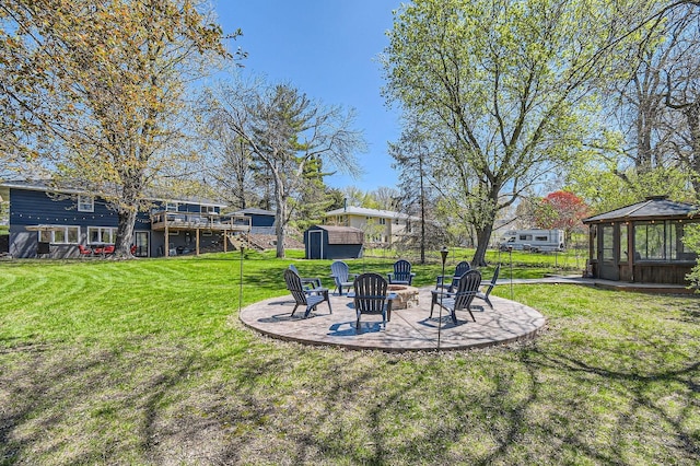13812 Steven Rd, Burnsville, MN 55337 - view of green lawn featuring a fire pit, a gazebo, a patio, a wooden deck, and stairs