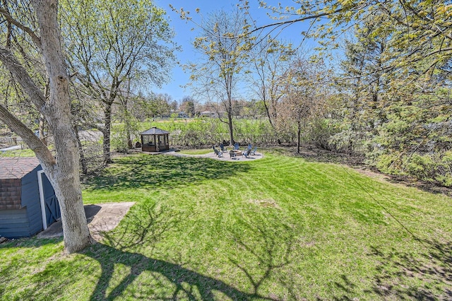 13812 Steven Rd, Burnsville, MN 55337 - view of grassy yard with a gazebo, an outdoor fire pit, and a patio area