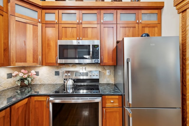 15795 Quebec Cir, Eden Prairie, MN 55346 - kitchen with stainless steel appliances, brown cabinetry, and decorative backsplash