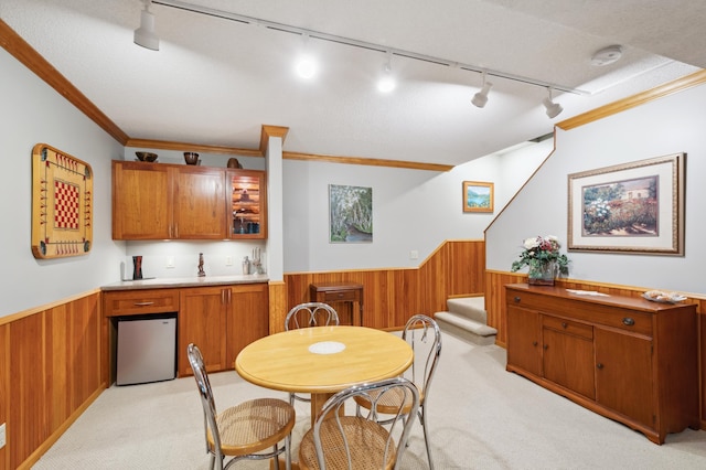 15795 Quebec Cir, Eden Prairie, MN 55346 - dining room featuring a wainscoted wall, wood walls, light colored carpet, track lighting, and stairs