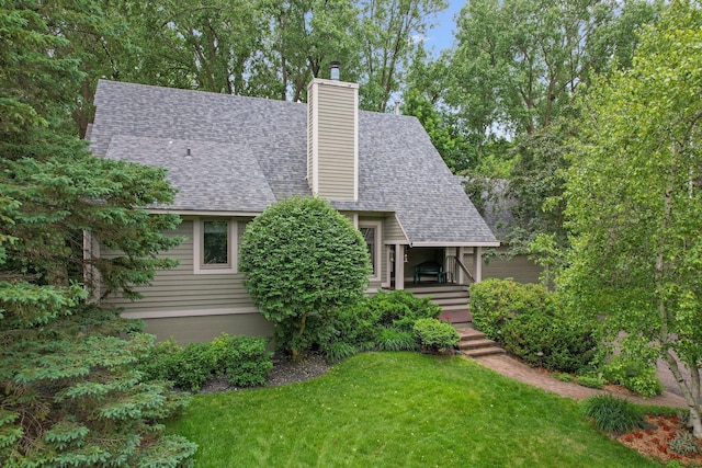 15795 Quebec Cir, Eden Prairie, MN 55346 - view of front of house with a shingled roof, a front yard, a chimney, and a porch