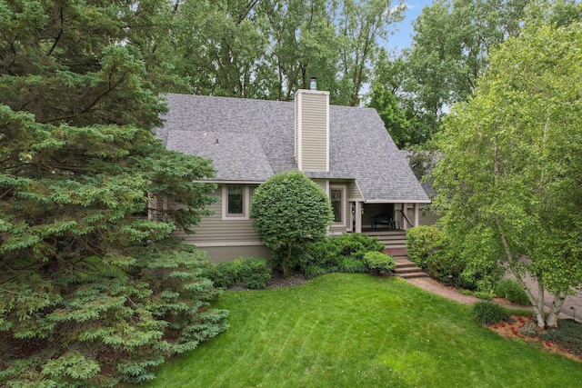 15795 Quebec Cir, Eden Prairie, MN 55346 - view of front of home with a shingled roof, a front lawn, a chimney, and a porch