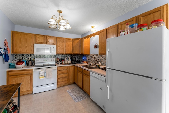 1587 County Road D E Unit B, Maplewood, MN 55109 - kitchen featuring white appliances, a chandelier, decorative backsplash, light countertops, and a textured ceiling