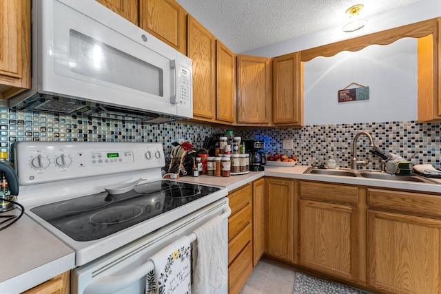 1587 County Road D E Unit B, Maplewood, MN 55109 - kitchen featuring white appliances, light countertops, tasteful backsplash, a textured ceiling, and brown cabinetry
