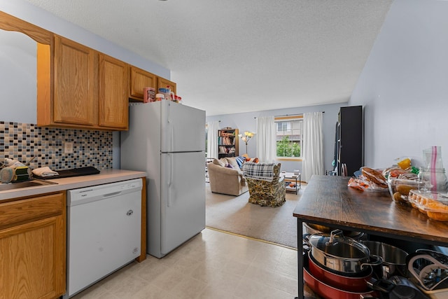 1587 County Road D E Unit B, Maplewood, MN 55109 - kitchen featuring white appliances, backsplash, a textured ceiling, light countertops, and brown cabinets