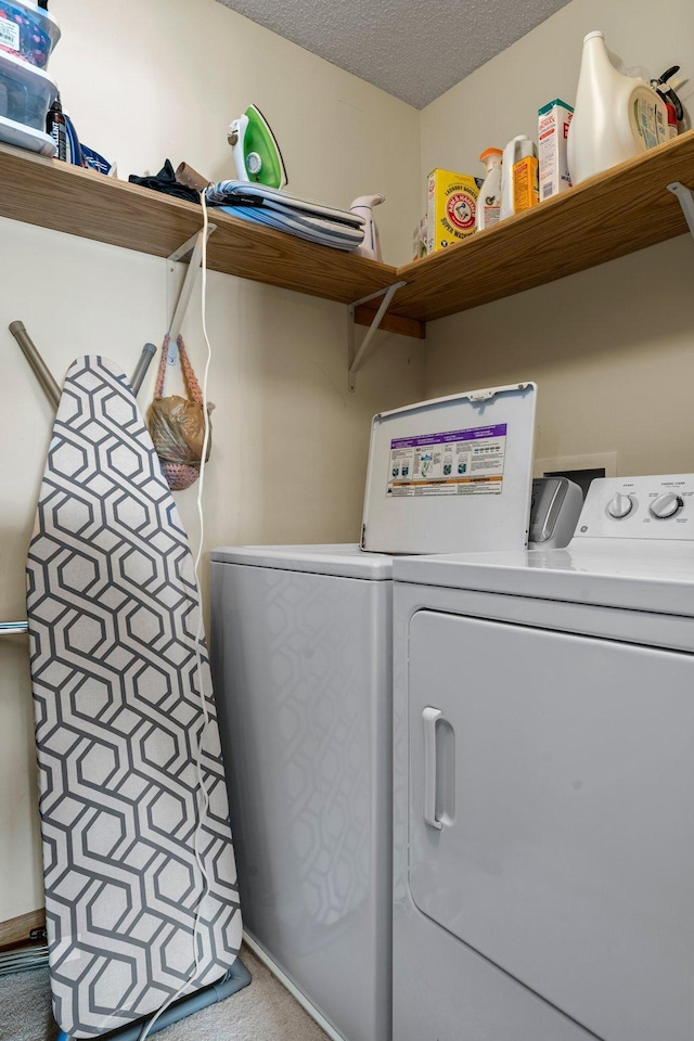 1587 County Road D E Unit B, Maplewood, MN 55109 - washroom with washing machine and clothes dryer and a textured ceiling