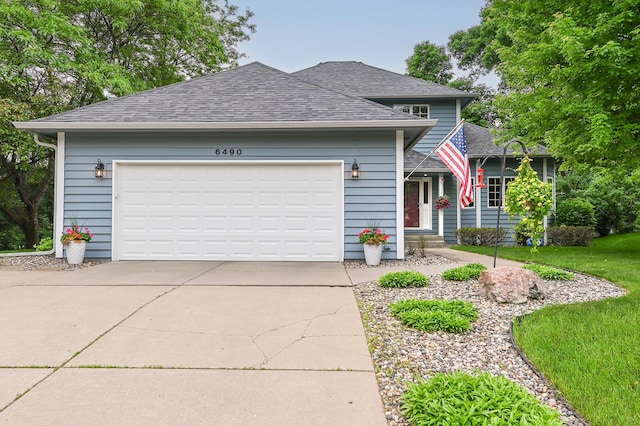 6490 White Dove Dr, Excelsior, MN 55331 - view of front of house featuring roof with shingles, concrete driveway, and an attached garage