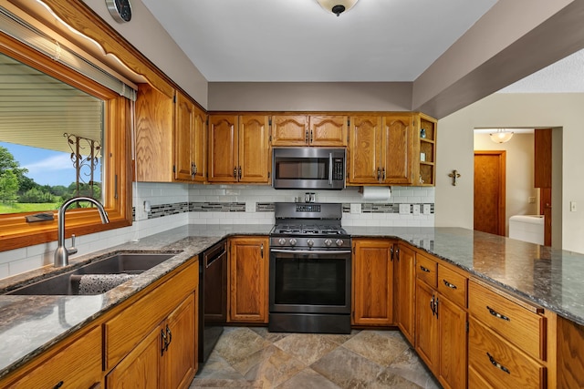 1341 75th Ave NE, Sauk Rapids, MN 56379 - kitchen with appliances with stainless steel finishes, brown cabinetry, decorative backsplash, and dark stone counters