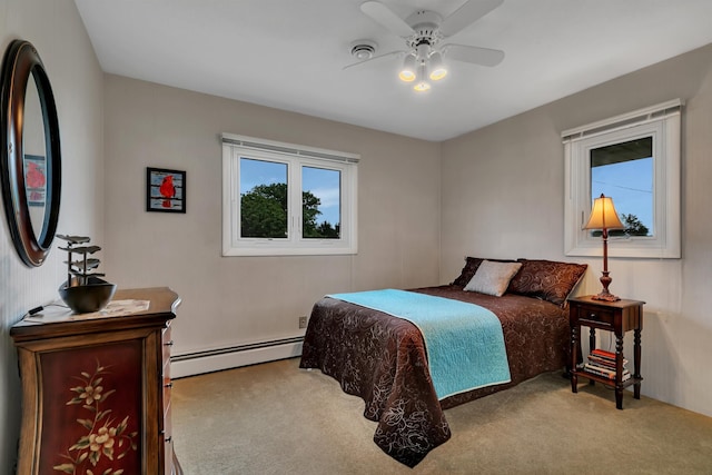 1341 75th Ave NE, Sauk Rapids, MN 56379 - carpeted bedroom featuring a baseboard heating unit and a ceiling fan