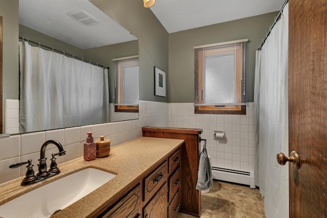 1341 75th Ave NE, Sauk Rapids, MN 56379 - full bathroom featuring a baseboard radiator, tile walls, and vanity