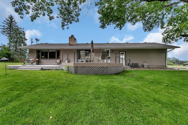 1341 75th Ave NE, Sauk Rapids, MN 56379 - rear view of property featuring a chimney, a lawn, and a wooden deck