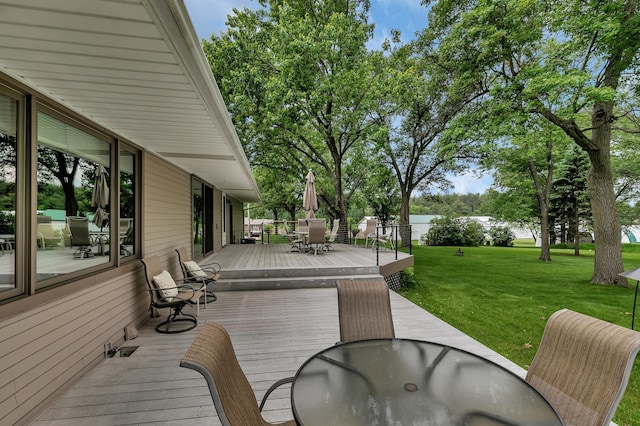 1341 75th Ave NE, Sauk Rapids, MN 56379 - wooden terrace with outdoor dining space, a yard, and a water view