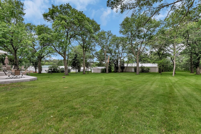 1341 75th Ave NE, Sauk Rapids, MN 56379 - view of grassy yard featuring a patio