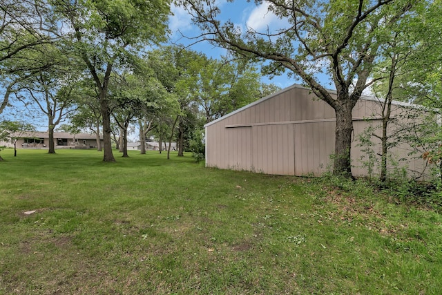 1341 75th Ave NE, Sauk Rapids, MN 56379 - view of green lawn featuring a garage and an outbuilding