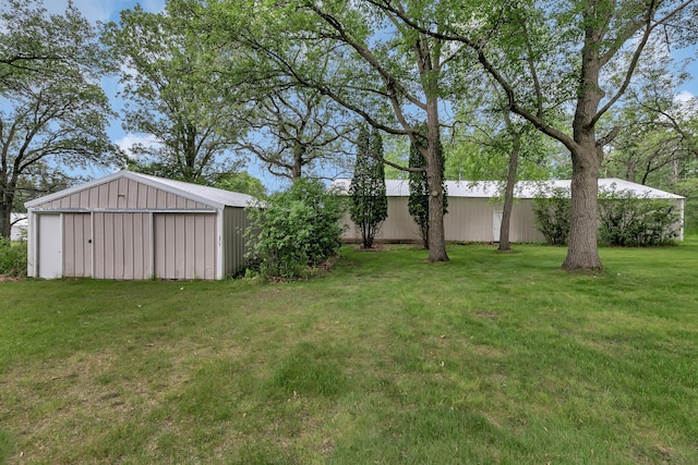 1341 75th Ave NE, Sauk Rapids, MN 56379 - view of green lawn with a pole building, an outbuilding, and a garage