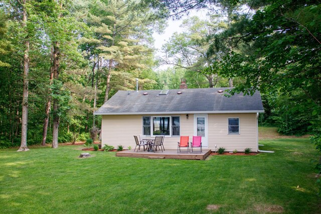 15088 Shady Oak Ln, Center Twp, MN 56465 - back of house with a deck, a lawn, a chimney, and a shingled roof