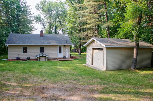 15088 Shady Oak Ln, Center Twp, MN 56465 - rear view of property featuring a garage, an outbuilding, a chimney, a yard, and a deck