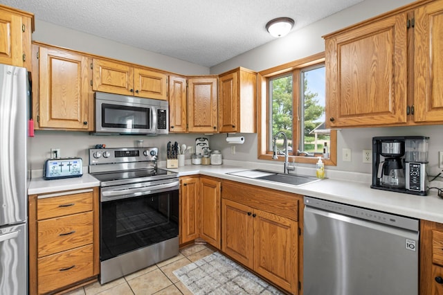 32147 111 1/2 St, Baldwin Twp, MN 55371 - kitchen with appliances with stainless steel finishes, a sink, light countertops, and a textured ceiling