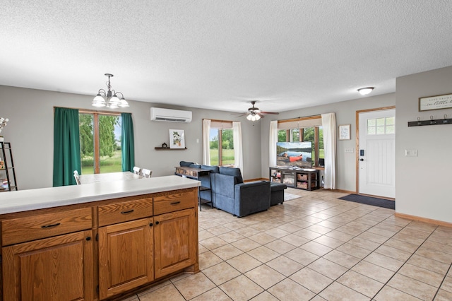 32147 111 1/2 St, Baldwin Twp, MN 55371 - kitchen featuring an AC wall unit, a textured ceiling, a chandelier, light countertops, and light tile patterned flooring