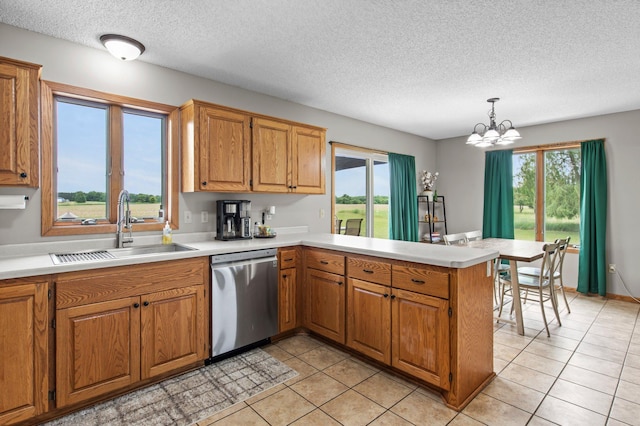 32147 111 1/2 St, Baldwin Twp, MN 55371 - kitchen featuring stainless steel dishwasher, a sink, a peninsula, a textured ceiling, and light countertops