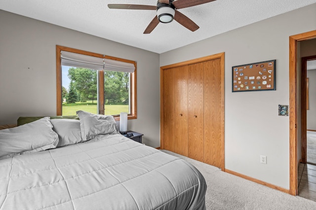 32147 111 1/2 St, Baldwin Twp, MN 55371 - bedroom featuring a closet, carpet floors, a ceiling fan, baseboards, and a textured ceiling