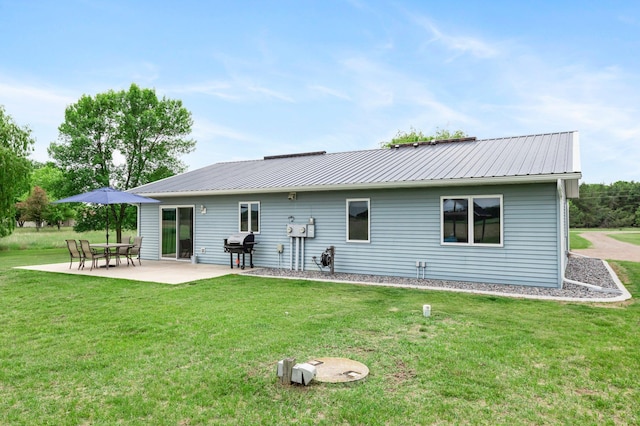 32147 111 1/2 St, Baldwin Twp, MN 55371 - rear view of property with a patio, a lawn, and metal roof