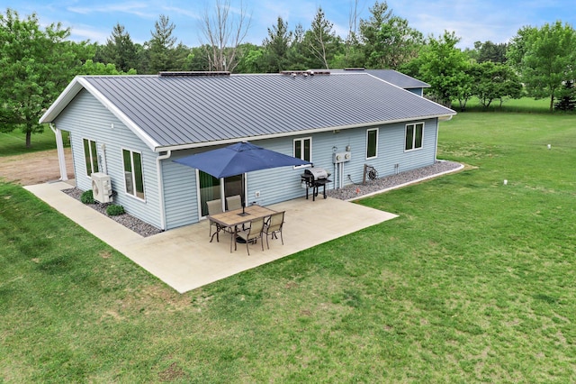 32147 111 1/2 St, Baldwin Twp, MN 55371 - back of house with a patio area, metal roof, a lawn, ac unit, and a standing seam roof
