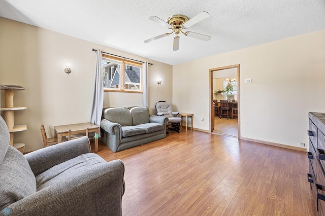 1307 5th St S, Fargo, ND 58103 - living area featuring light wood-style flooring, a ceiling fan, and a textured ceiling