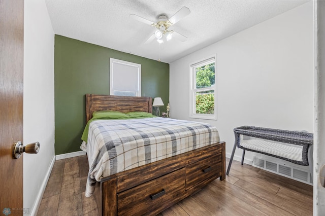 1307 5th St S, Fargo, ND 58103 - bedroom with wood finished floors, a textured ceiling, and a ceiling fan