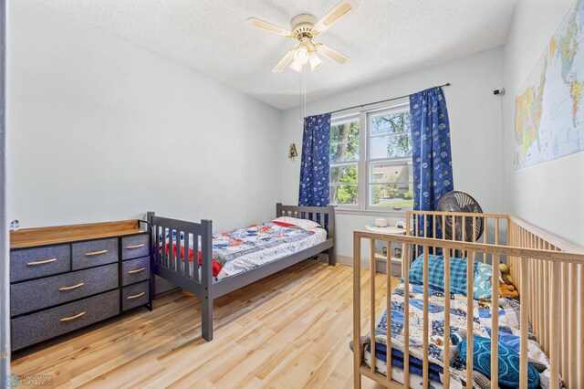 1307 5th St S, Fargo, ND 58103 - bedroom featuring light wood finished floors, a textured ceiling, and a ceiling fan