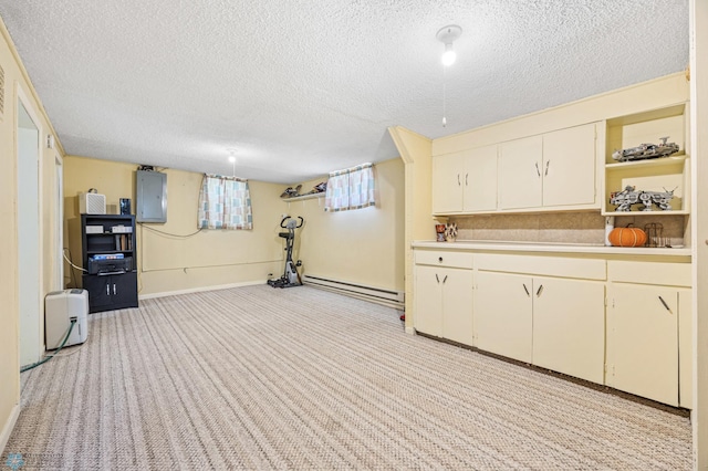 1307 5th St S, Fargo, ND 58103 - exercise area with a baseboard heating unit, electric panel, a textured ceiling, and light carpet