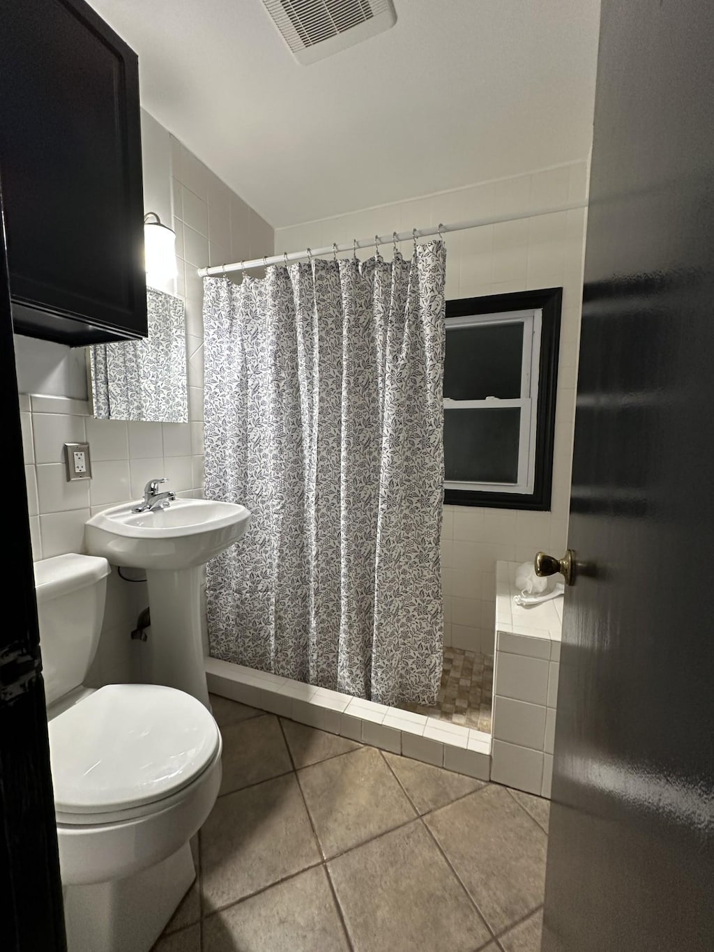 644 82nd Ave NE, Spring Lake Park, MN 55432 - full bathroom featuring tile patterned flooring, tile walls, and a tile shower