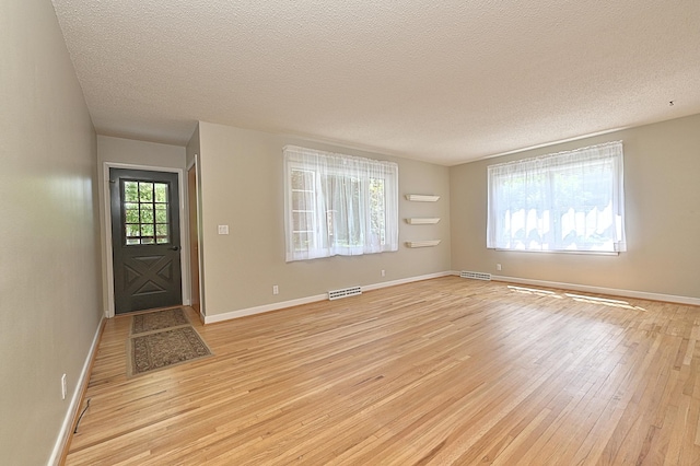 619 9th Ave, Grand Rapids, MN 55744 - foyer featuring light wood-style floors, a textured ceiling, and baseboards