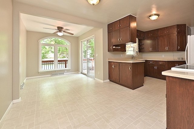 619 9th Ave, Grand Rapids, MN 55744 - kitchen with ceiling fan, light countertops, baseboards, dark brown cabinetry, and a sink